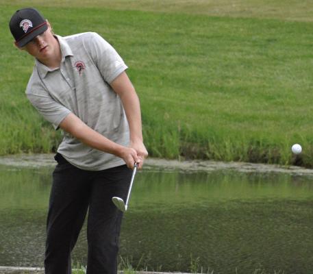 JUNIOR ISAAC KAYLOR watches one of his chip shots during the Richmond Invitational.