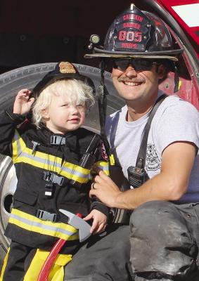 LIAM JOHNSON (left) dresses like his uncle, Wood Heights firefighter Kody Gaines. SHARON DONAT | Staff