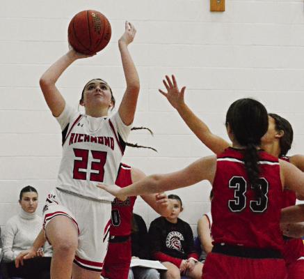 RICHMOND SOPHOMORE Emma Hash draws a pack of Bulldogs as she attempts a second-half layup against Odessa Monday night in the Husker Classic in the west gym of the Lafayette County C-1 campus in Higginsville. SHAWN RONEY | Staff