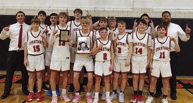 MEMBERS OF the Richmond Middle School boys basketball A team enjoy their end-of-season tournament title Jan. 25 at Knob Noster. From left are, front row, Jaxton Smith, Cale Moyer, Jack Minton, Latimer Cavanah, Carson Persell, Mason Minnick and Elan Griffin; back row, head coach Shawn Calhoun, Caige Castilleja, Chase Plonski, Dayton Palier, Kypton Burnett, Amos Farnan, Bryson Pruitt and assistant coach Bret Higgins. COURTESY OF THE RMS FACEBOOK PAGE | Submitted