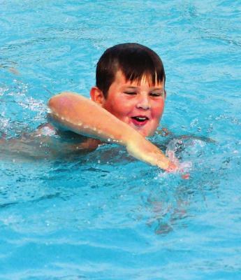 DOLPHIN Swim Team member Jett Shane swims a few freestyle strokes after diving into deep water during his swim-a-thon Sunday at Southview Pool to raise money for the Arthritis Foundation. SHAWN RONEY | Staff