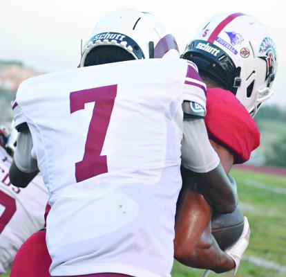MASON THOMAS-ANDERSON of Mary Institute Country Day School (left) attempts to tackle Richmond senior Malikiah Tharp during the first half of a varsity 11-man football clash between schools from opposite sides of Missouri. SHAWN RONEY | Staff