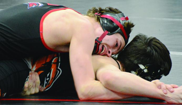 SENIOR BRADY HYDER works on the right arm of Kirksville’s Jason Schutter while wrestling in the top position during the title match for the 126-pound division at the Richmond Invitational. It was Hyder’s final home match. SHAWN RONEY | Staff