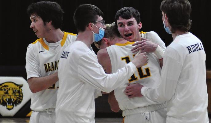LED BY senior Ethan Wilson embracing junior Blake Buchanan, the Bearcats celebrate their sectional victory Tuesday night at Orrick. SHAWN RONEY | Staff