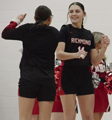 CANDIACE CLAYPOLE (right) shows she’s ready to play as she is introduced before Richmond’s Husker Classic opener with Excelsior Springs. SHAWN RONEY | Staff