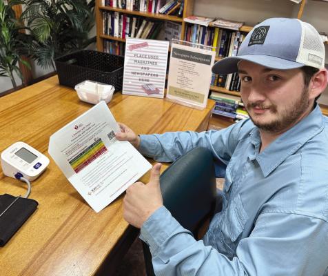 AN AREA RESIDENT reads up on ways to monitor blood pressure. JOSHUA BRUNGARDT | Staff