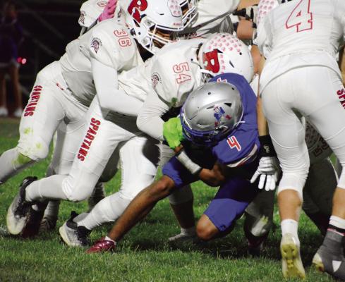 ASSISTED BY Hayden Happy, No. 36, and others, Richmond junior Trent Logsdon, No. 54, leads the way in making a tackle Oct. 21 at Lexington. SHAWN RONEY | Staff