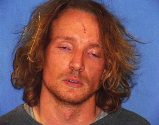 WITH GRASS still in his hair following his arrest near Elkhorn Elementary School, in a farmer’s field where he appeared to be trying to hide from law enforcers, Richard Anthony Arrington, 30 Kansas City, is photographed during booking.