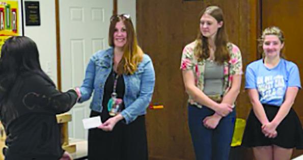 GUYS &amp; GALS 4H Treasurer Trinity Thomas (from left) presents a check to Dear Elementary affiliate Sarah Kennedy with President Taylor Reeves and Vice President Amanda Wollard. Submitted
