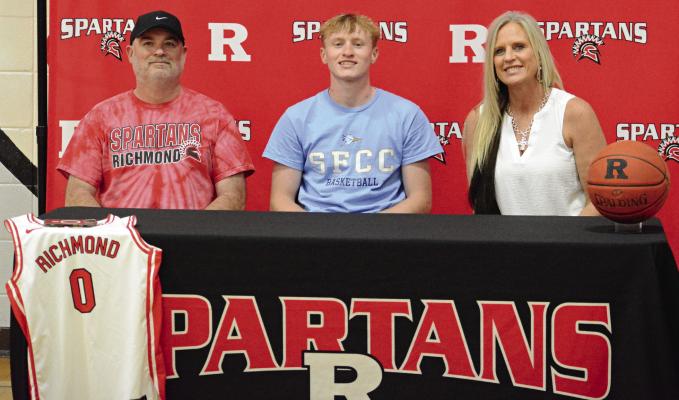 NOLAN QUICK (center) celebrates his decision to study at and play men’s basketball for State Fair Community College in Sedalia with his parents Aaron (left) and Tammy Quick. SHAWN RONEY | Staff
