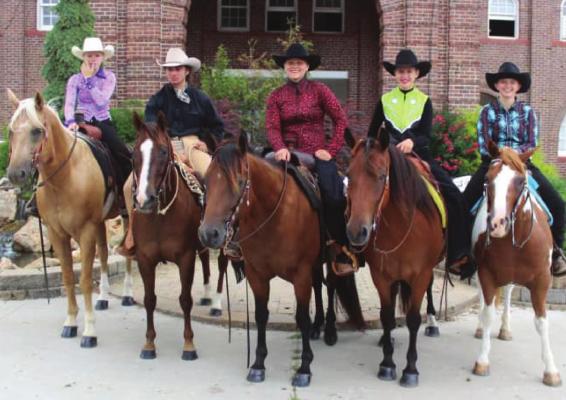GUYS AND GALS 4-H members with their horses stand outside the State Fairgrounds last week during competition.