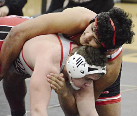 RICHMOND SENIOR Hayden Happy (top) works to break down Odessa’s Zeke Bergen in the 190-pound Class 2 District 4 wrestleback semifinals Feb. 17 at Excelsior Springs. SHAWN RONEY | Staff