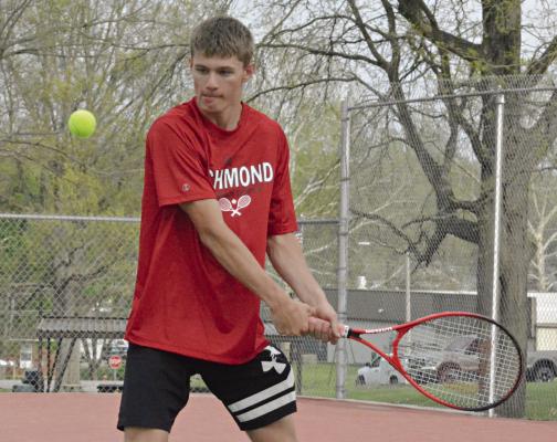 GABE BAKER is set to hit a two-hand backhand shot Monday against Excelsior Springs’ Colt Bowman Monday at Richmond. SHAWN RONEY | Staff