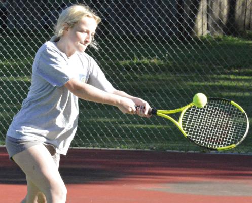 CARSYN TEAT works on her two-fisted backhand during a training session for Richmond High School girls. SHAWN RONEY | Staff