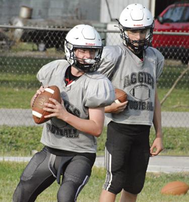 COUSINS AND NORBORNE HARDIN-CENTRAL teammates Zach Deitch (left) and Brody Fifer work on their passing accuracy and engage in some friendly family competition at team camp June 30 at Hardin-Central. SHAWN RONEY | Staff