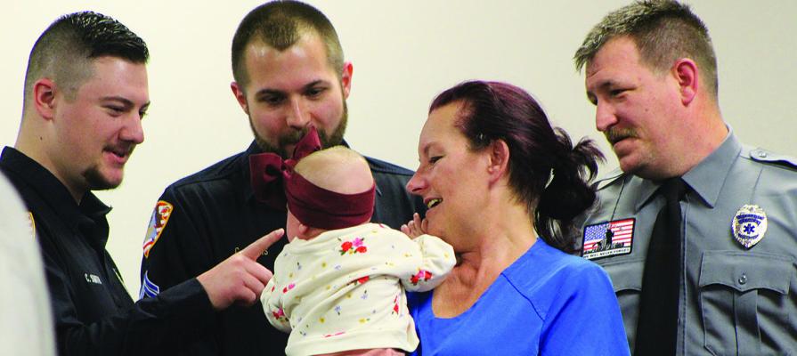 FIRST RESPONDERS interact with baby Everly and her aunt during the Life Saver Award ceremony recognizing local emergency crews. SHARON DONAT | Staff