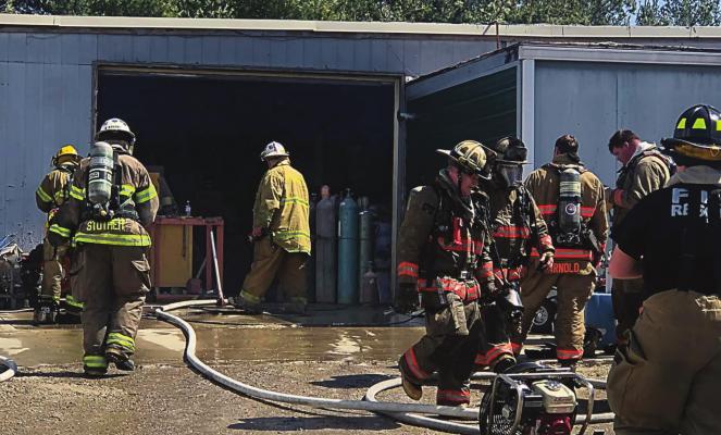 FIREFIGHTERS from Richmond and area communities contain a business fire on East Main Street. RICHMOND FIRE DEPARTMENT