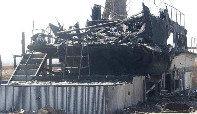 STRUCTURAL DAMAGE remains visible in the Sunshine Lake area after multiple agencies responded to a fast-moving fire. MIRANDA JAMISON | Staff