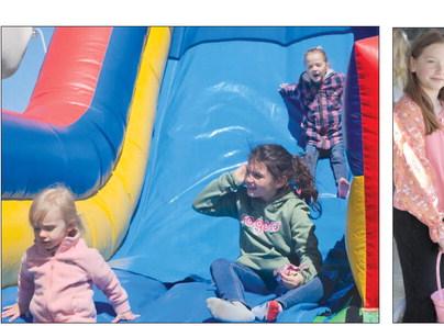 CHILDREN MAKE their way down an inflatable slide as Easter festivities MIRANDA JAMISON | Staff