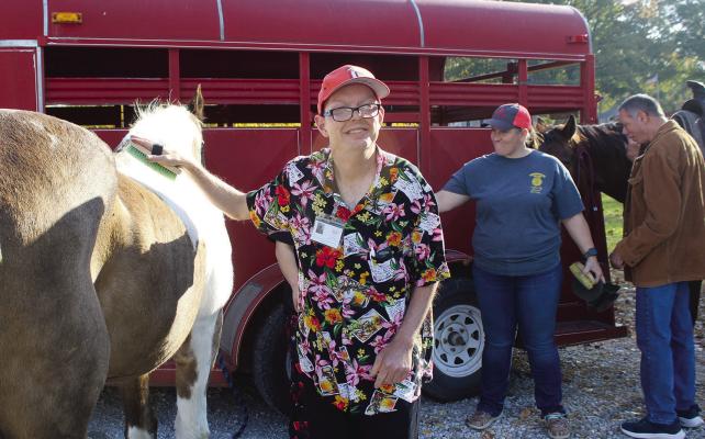 SHARON DONAT | Staff JOHN BUCHER enjoys brushing a horse during the FFA petting zoo at Ideal Industries.