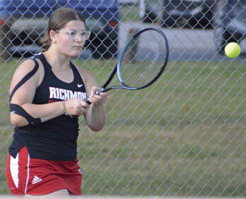 SENIOR AVA BOZARTH hits a two-fisted backhand shot during her singles match against Cameron. Bozarth helped the Spartans win the varsity girls tennis dual 5-4. SHAWN RONEY | Staff