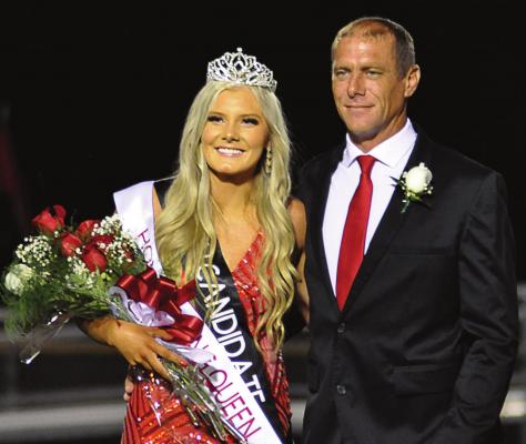 SENIOR EMMALEA KILPATRICK, escorted by her dad, Jeremy, is crowned homecoming queen during halftime of Richmond’s 35-26 Sept. 24 homecoming loss. Collin Cromley is crowned king. SHAWN RONEY | Staff