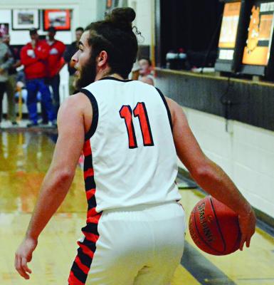 DENVER DOUGLAS shields the ball with his hip as he looks to make a firsthalf pass for Hardin-Central Dec. 7 against visiting Carrollton. SHAWN RONEY | Staff