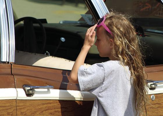 CURIOSITY GETS the best of Cate Kerste, as she examines the interior of a classic car during the car show, which raised funds for the class of 2027’s after-prom. SHARON DONAT | Staff