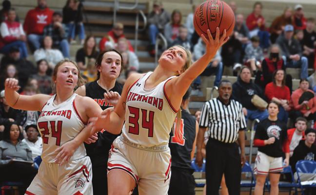 SENIOR EMMALEA KILPATRICK reaches for a second-half rebound while Richmond teammate Laney Moyer is ready to assist during the Spartans’ 39-32 victory over Oak Grove Jan. 28 at Richmond Middle School. SHAWN RONEY | Staff