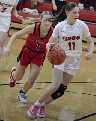 RICHMOND JUNIOR Candiace Claypole (right) drives the lane with Lawson’s Madi Cross close behind her during Richmond Winter Classic girls championship game action. SHAWN RONEY | Staff