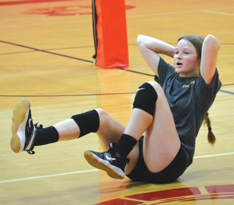 KELLY JAGGARS does her bicycle crunches Monday morning during volleyball camp in the Richmond High School gym. SHAWN RONEY | Staff