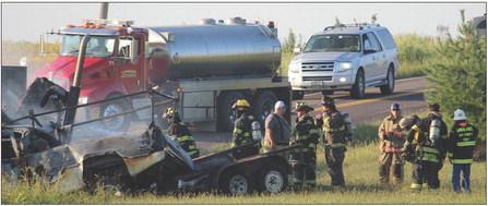 WOOD HEIGHTS, Excelsior Springs and Lawson Fire Departments work together to extinguish flames on the burning vehicles after a fatal head-on collision. MIRANDA JAMISON | Staff