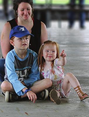SITTING with their mother, Lauren Odil, are Ellis, 8; and Lark, 2. They watch “The Ogre’s Tail.” J.C. VENTIMIGLIA | Staff