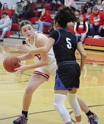 RICHMOND SOPHOMORE Emma Hash looks to pass around Summit Christian Academy sophomore Aaliyah Daniels Dec. 14 in varsity girls basketball action at Richmond. SHAWN RONEY | Staff