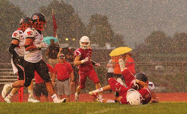 DURING A DOWNPOUR early in the second quarter, senior wide receiver Layne Cavanah pulls in a pass thrown from the 29-yard line by senior quarterback Keyshaun Elliott. Good for 18 yards, the play sets up Elliott’s first rushing touchdown against Oak Grove. J.C. VENTIMIGLIA | Staff