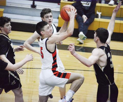HARDIN-CENTRAL junior Kameron Pugh looks to shoot over the outstretched arm of Norborne senior Kobe Gibson Monday night at Norborne. SHAWN RONEY | Staff