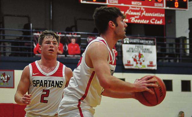 SHAWN RONEY | Staff COLLIN CROMLEY looks set to shoot as teammate Layne Cavanah watches.