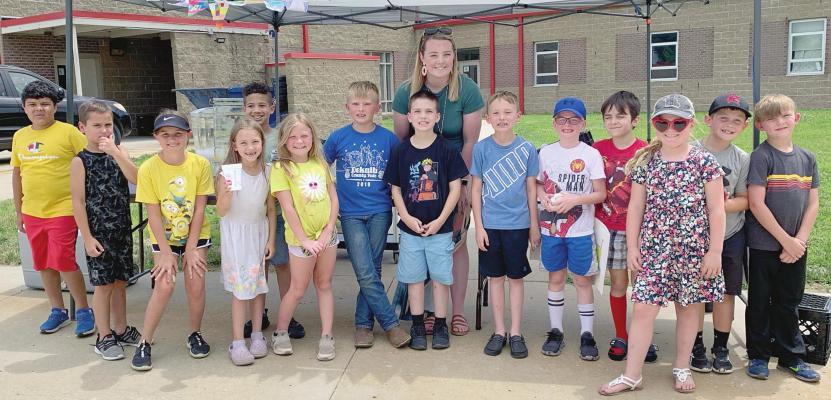 ALAZE CHOWNING and her class of second-grade summer school students run a lemonade stand at Sunrise Elementary, learning entrepreneurial skills and donating their profits to the school’s backpack program.