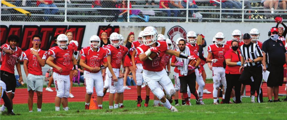 J.C. VENTIMIGLIA | Staff ON A SLOPPY FIELD at Richmond High School, junior wide receiver Layne Cavanah hauls in a pass from junior quarterback Keyshaun Elliott around Fulton’s 25-yard line, leading to the team’s first score in a 42-7 victory.