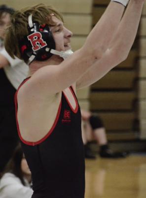 RICHMOND SOPHOMORE Raiden Sullivan raises his arms triumphantly after his win over Pleasant Hill’s Evan Neely at Class 2 District 4 boys wrestling competition. SHAWN RONEY | Staff
