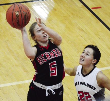 RICHMOND JUNIOR Laney Moyer attempts a first-half, one-handed jump shot in the paint as Gallatin senior Presley Wells attempts to guard her Jan. 13 in fifth-place tournament action at Lawson High School. SHAWN RONEY | Staff