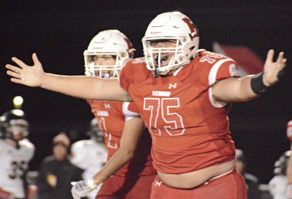 WITH HIS arms spread, Richmond senior Jake Cringan is ready for bro hugs after his third-quarter interception Oct. 13 against visiting Knob Noster. SHAWN RONEY | Staff