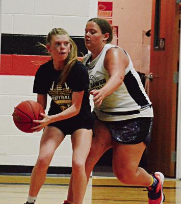 GUARDED BY Hardin-Central’s Hannah Finley, Orrick’s Addison Chapman eyes the court from the baseline June 22 at Hardin-Central. SHAWN RONEY | Staff