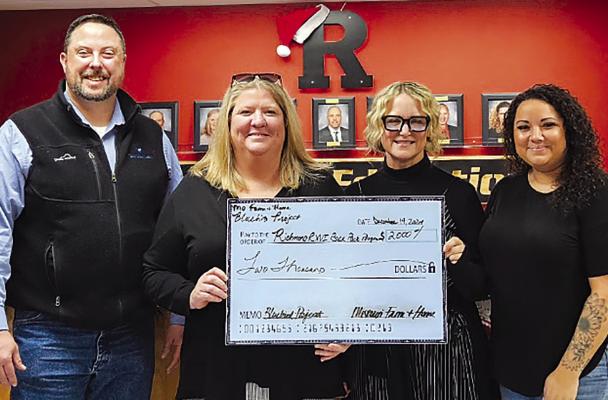 MISSOURI FARM AND HOME CEO Jimmy Carter (from left) and Carrie Mueller present a $2,000 donation check to Richmond School District Administrative Support Staff members Amy Wirsig and Nicole Yoakum on behalf of the Backpack Program. MIRANDA JAMISON | Staff