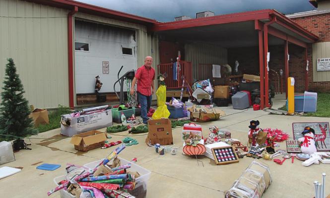 SALVATION Army Store Director Phil Powers stands amid items that went through basement flooding from the fire hoses used to put out the building fire. The items, many in good shape, are marked down by 75%, he says. J.C. VENTIMIGLIA | Staff