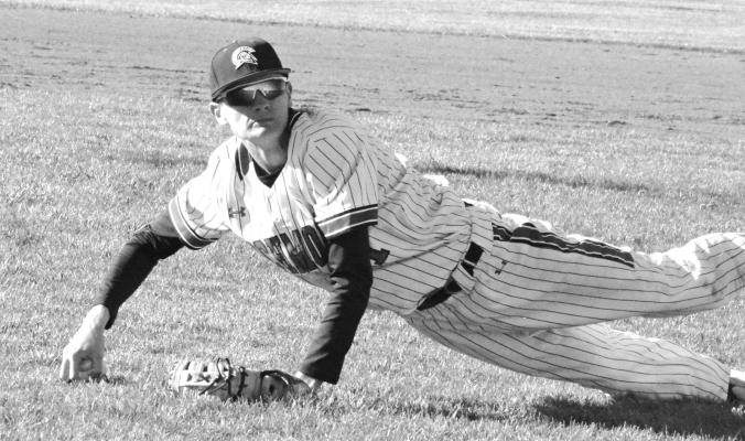 HUNTER MITCHELL looks to throw to first base after diving to field an infield blooper during Richmond’s April 4 varsity baseball meeting with Benton, a St. Joseph-based school, at Southview Park. SHAWN RONEY | Staff