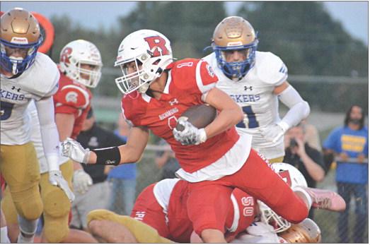 WITH THE football tucked under his left arm, first-year high schooler Dryden Hendrix rumbles for yardage during the first half of Richmond’s Sept. 22 homecoming meeting with Lafayette County of Higginsville. SHAWN RONEY | Staff
