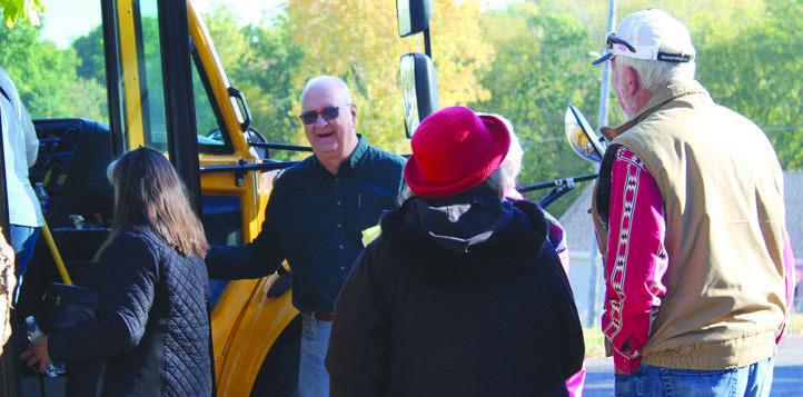 HAL MIDDLETON (second from left) ushers history tour participants onto the bus. SHARON DONAT | Staff