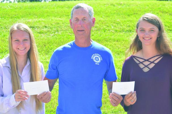 HAROLD STROBEL AWARD recipients Ashley Stewart and Alexis Reeves accept their gifts from Frazer Letzig. The girls are awarded with $250 each. TARA ALTIS | Staff