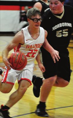SENIOR KORBIN PUGH drives the floor Monday against Norborne.